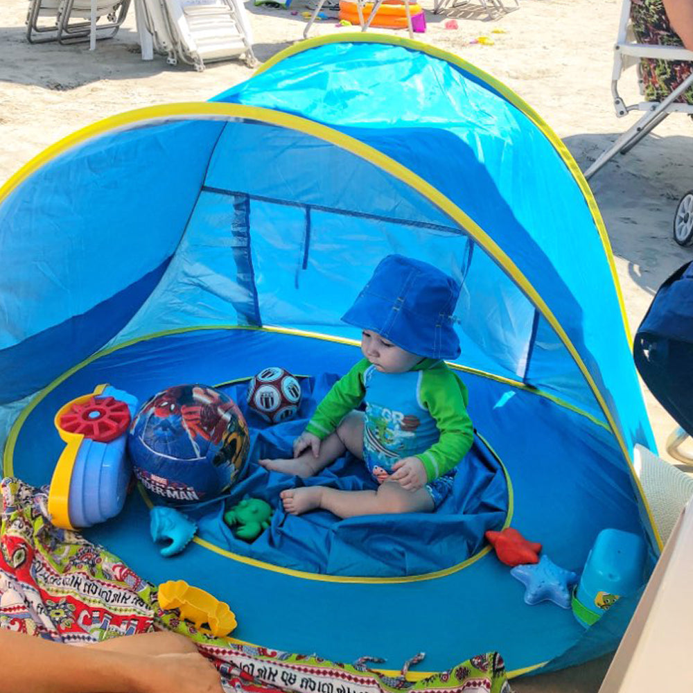 Baby sitting in Beach Tent